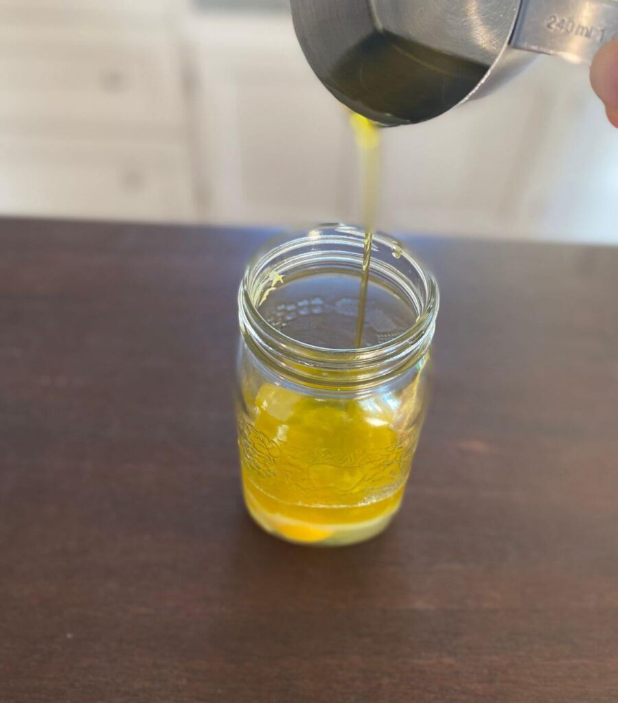Pouring oil into a jar of raw eggs.