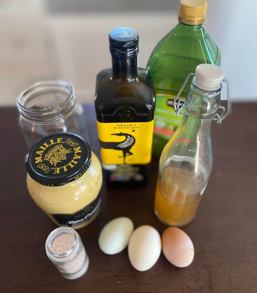 Ingredients for homemade mayo recipe with apple cider vinegar and a jar.