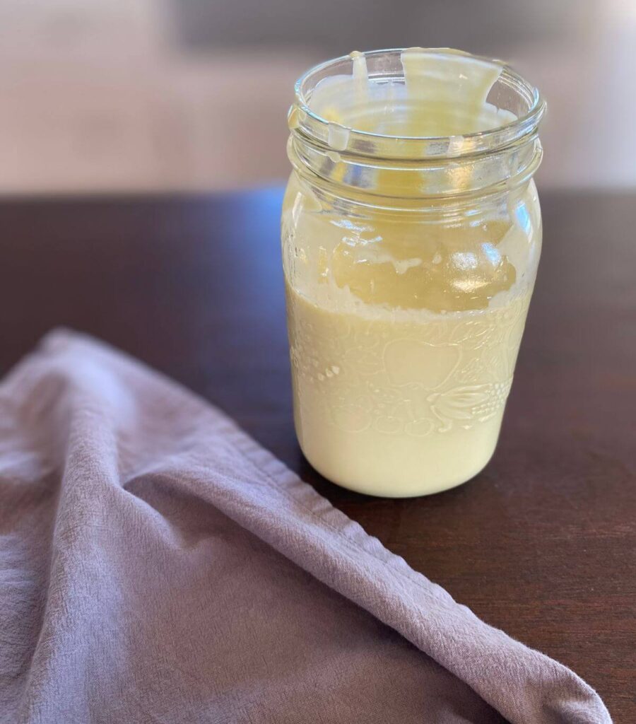 A mason jar of mayo with the lid off.