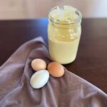 Jar of homemade mayo with 3 coloured eggs.