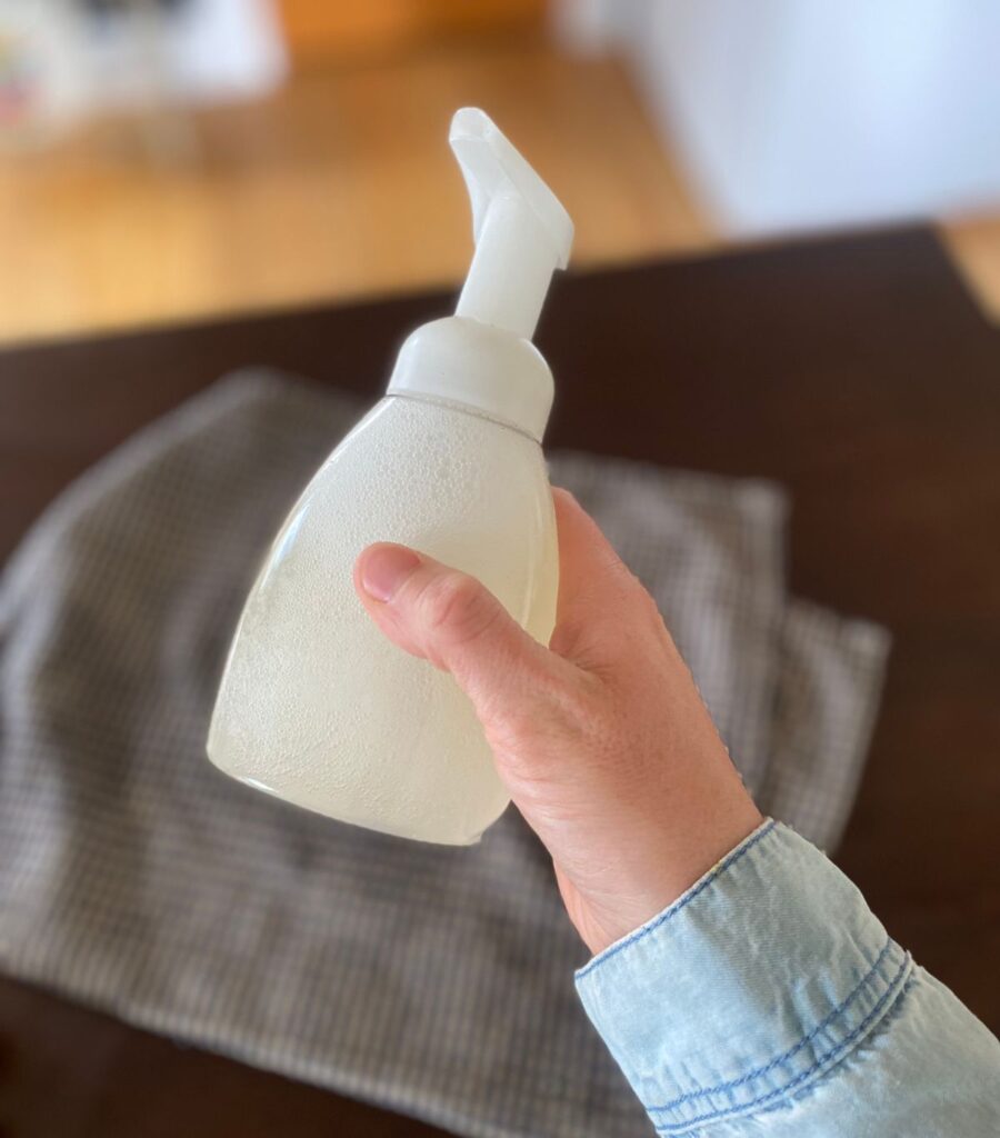 Shaking ingredients for DIY foaming hand soap to mix them together.